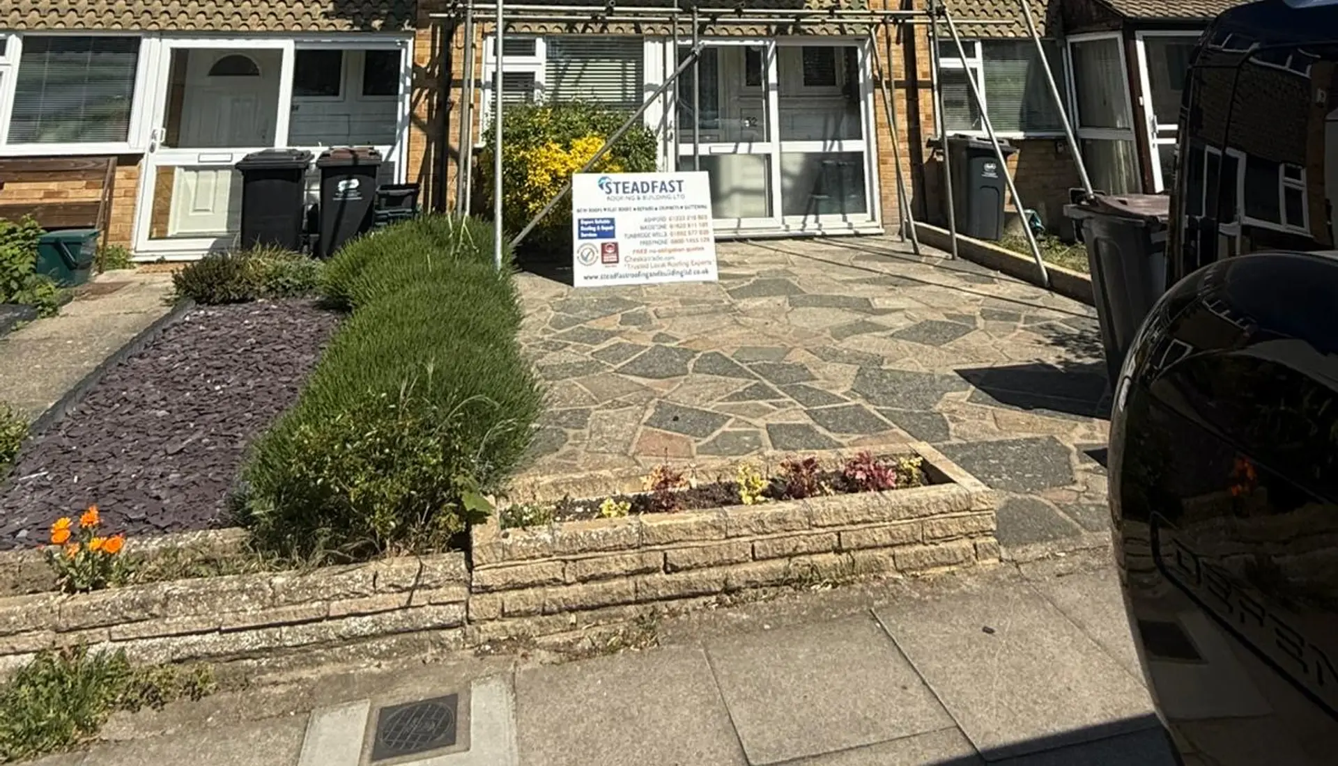 A Steadfast roofing job with scaffolding at a terraced house